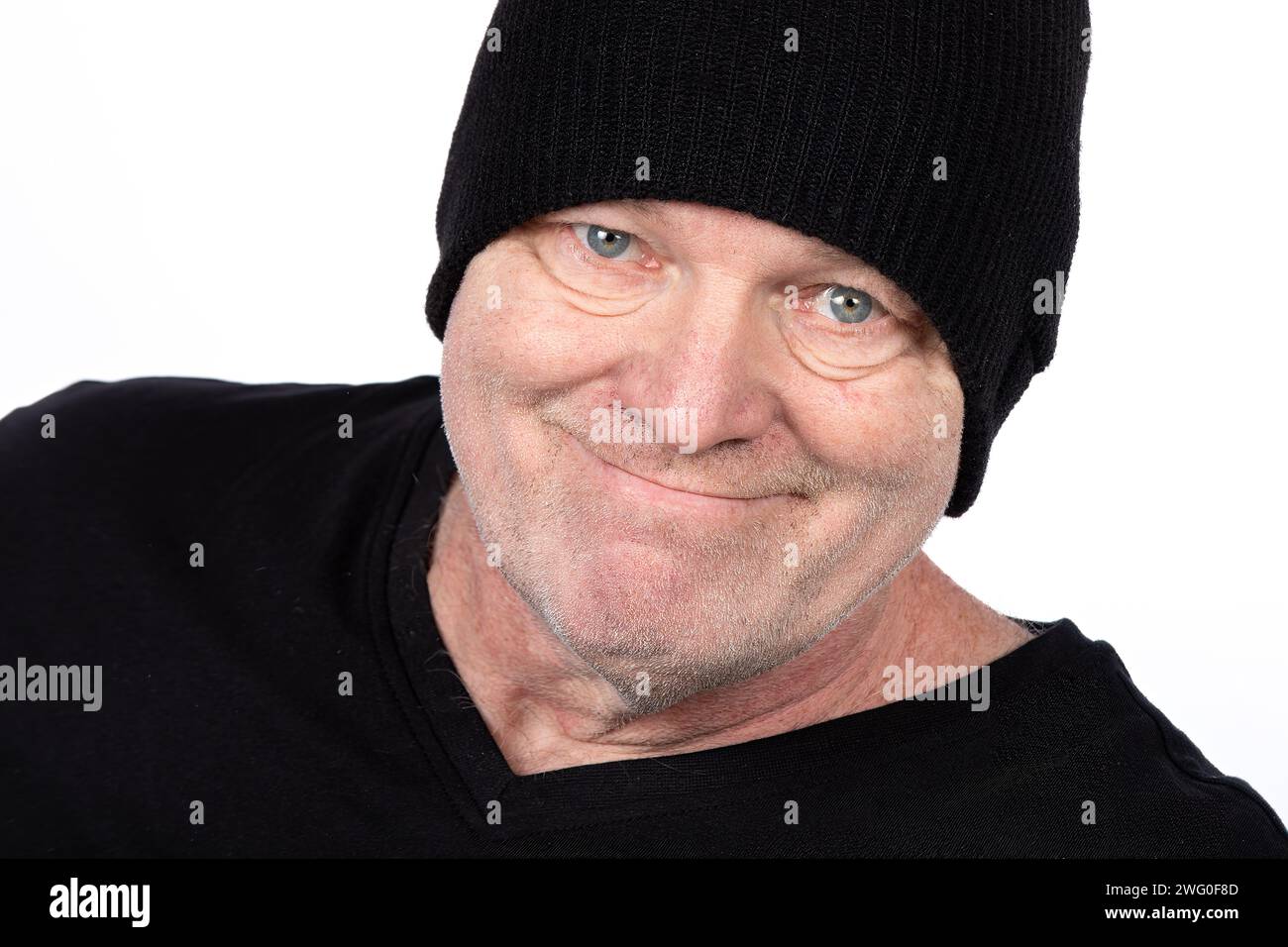 Smiling Middle-Aged Man in Black T-Shirt and Hat, Confident Portrait on White Background - Casual Lifestyle and Fashion for Mature Adults Stock Photo