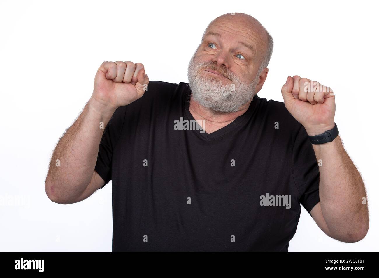 Middle-Aged Man Expressing Discomfort and Stress with Clenched Fists, Health Concept on White Background. Stock Photo