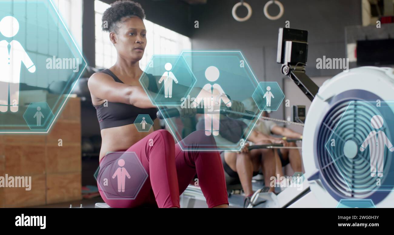 Image of people icons over diverse group training on rowing machines at ...