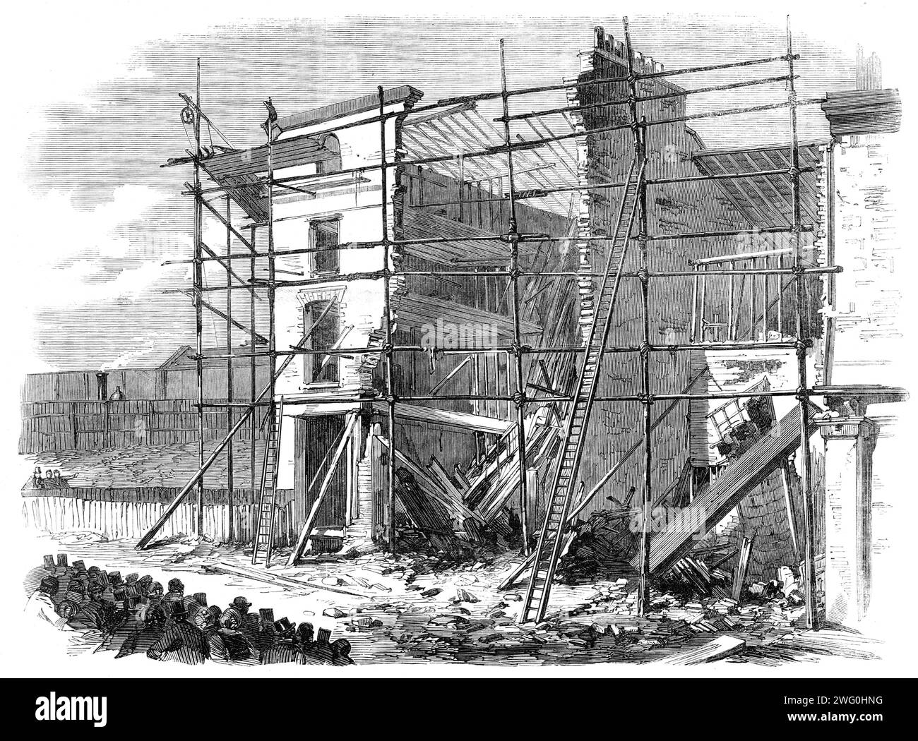 Fall of three houses in Amherst-road, Hackney, [London], 1862. 'On the morning of Wednesday week, between the hours of ten and eleven o'clock, the inhabitants of Hackney were thrown into great excitement in consequence of the fall of three new houses, attended with loss of life and serious injury to several persons. In the Amherst-road, close to the viaduct of the North London Railway, where it crosses the Hackney-road, are a number of new buildings, three-stories high, built by Mr. Amos, which were being finished in the interior by carpenters, plasterers, and other artisans, at the above hour Stock Photo