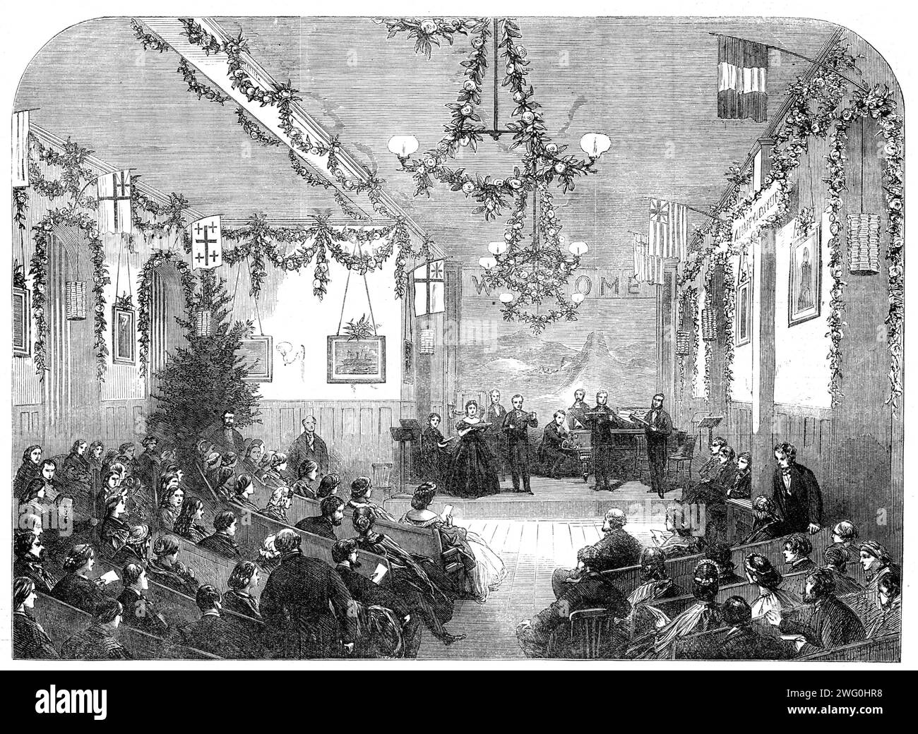 Winter entertainments at St. Luke's Hospital for Lunatics, [Old Street, London]: vocal and instrumental concert on Wednesday week, 1862. Concert '...for the amusement and recreation of the patients. The room is long and lofty...There are two recesses in its length which contain large windows, looking into the courtyard in front of the building, and which, in accordance with the plan of the building, break the monotony of a long wall, and afford excellent spaces in the rooms occupied by the patients for the placing of musical instruments, bagatelle-boards, worktables, &amp;c. In the concert-roo Stock Photo