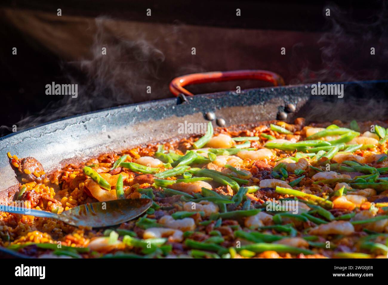 A close up of a large steel Paella dish and spoon cooking a seafood Paella at a market in Sydney, Australia Stock Photo