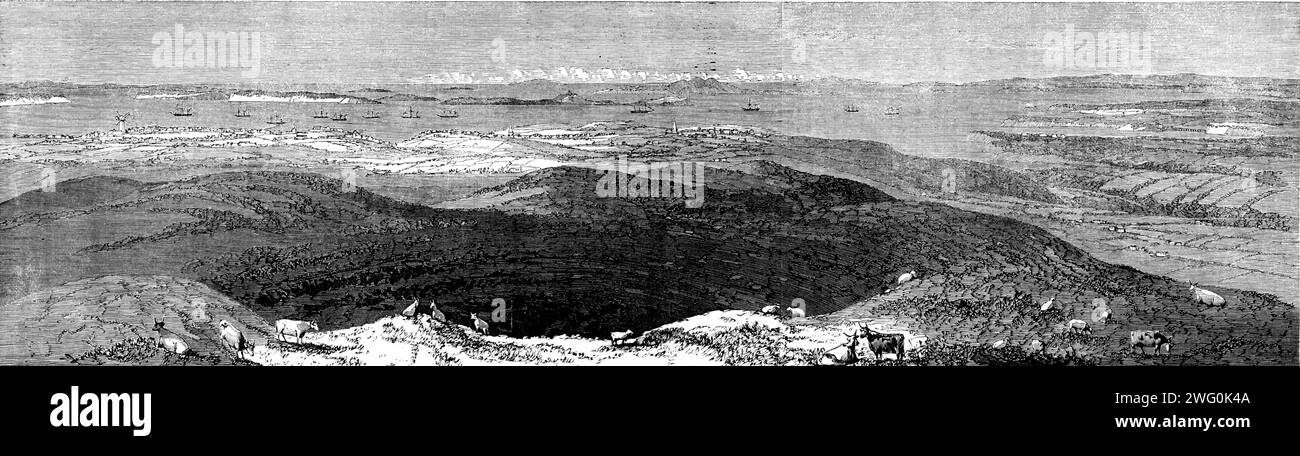 View of Auckland, from the crater of Mount Eden, from a drawing by Major Stack, 1862. 'The foreground of this Engraving represents an extinct crater, 600 yards in circumference, 200 yards in diameter, and about 60 or 70 yards in depth. The summit is about 1000ft. above the level of the sea, of which a fine view is obtained, dotted with numerous islands, the triple peaks of the extinct volcanic Rangitoto being most conspicuous, and the great and little barrier islands in the extreme distance... But the scenery for several miles around Auckland...is almost entirely devoid of wood, open, and undu Stock Photo