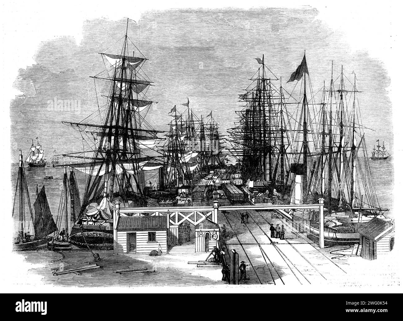 The Melbourne and Hobson's Bay Railway Company's pier at Sandridge, near Melbourne, Australia, 1862. In 1853-4, '... the cost of transit, by lighters from the shipping in the bay, via the circuitous route of the River Yarra Yarra, to the wharves in Melbourne averaged from 45s. to 35s. per ton, but, on the opening of this railway pier for traffic, these rates were reduced to one-seventh...It is constructed of the best colonial hardwood, supported upon blue gum piles...The pier is lighted with gas, and water...is laid on the entire length...From the period of its opening...upwards of half a mill Stock Photo