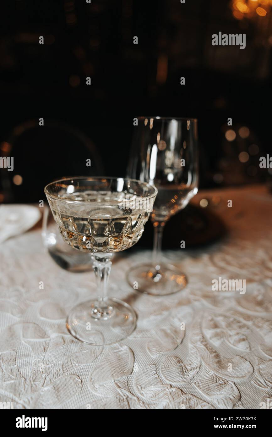 Two champagne glasses on lace, full and ready for a romantic toast Stock Photo