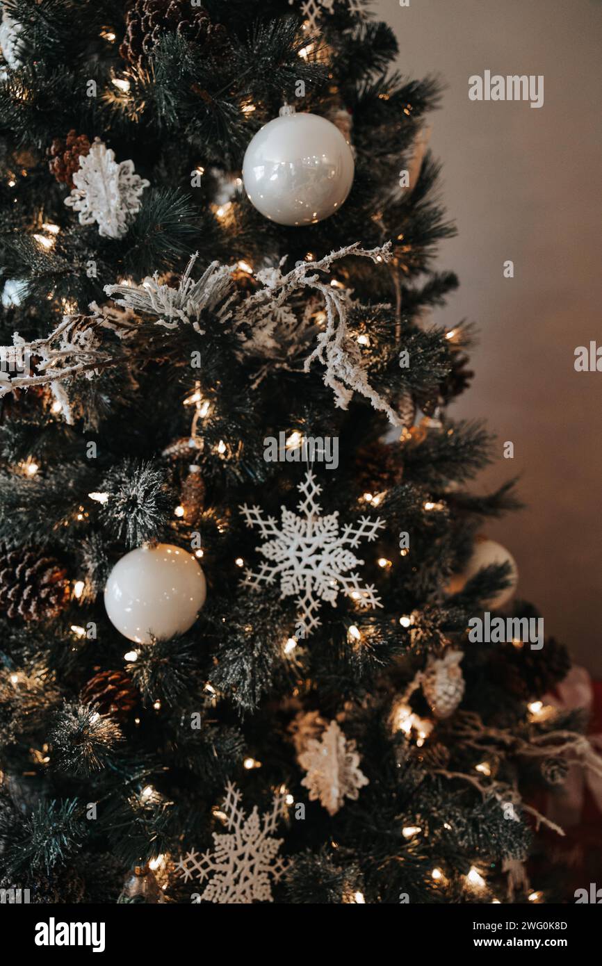 christmas tree adorned with white bulbs, snowflakes, and soft lights Stock Photo