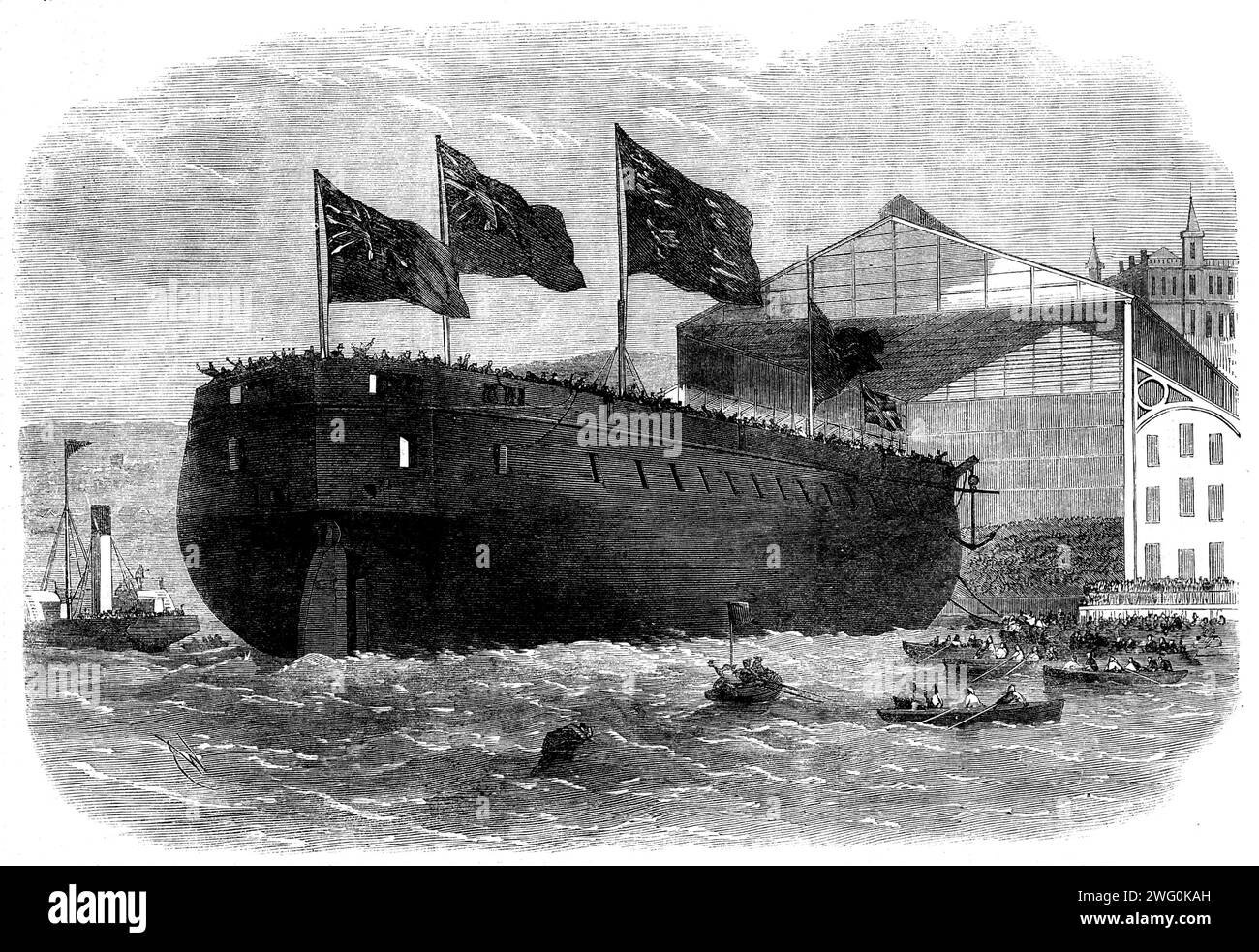 Launch of Her Majesty's armour-plated screw-frigate Caledonia, 31 guns, at Woolwich, [London], 1862. '...the vessel having been named by Miss Nicolson, daughter of the Commodore Superintendent, powerful jackscrews were applied to the keel, and the noble vessel glided down the launching-ways, and swung out into the centre of the river [Thames] amidst the cheers of the spectators, the bands performing &quot;Rule Britannia&quot;...The Caledonia was laid down about three years since as a 90-gun timber-frigate, hut, the Admiralty having abandoned the building of such vessels, she was altered and re Stock Photo