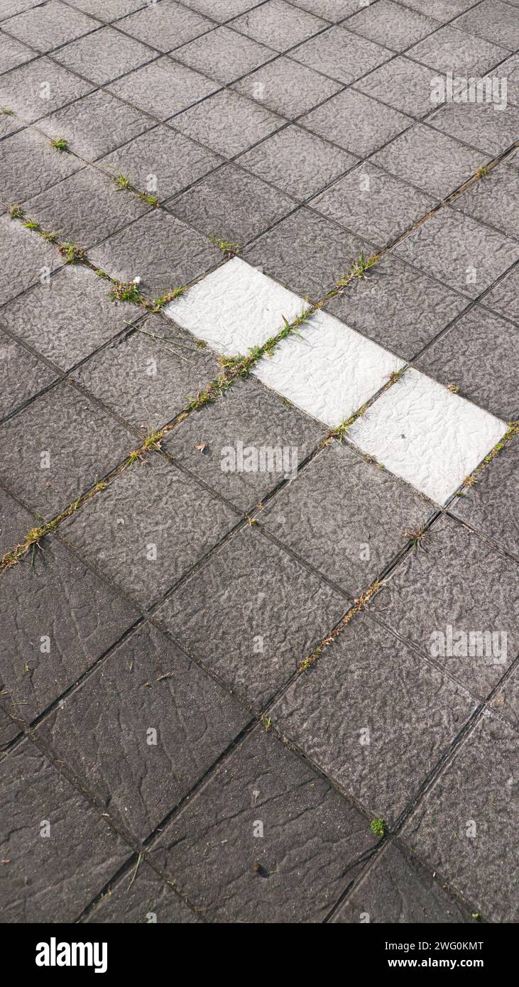 WHite tiles in grey ground Stock Photo Alamy