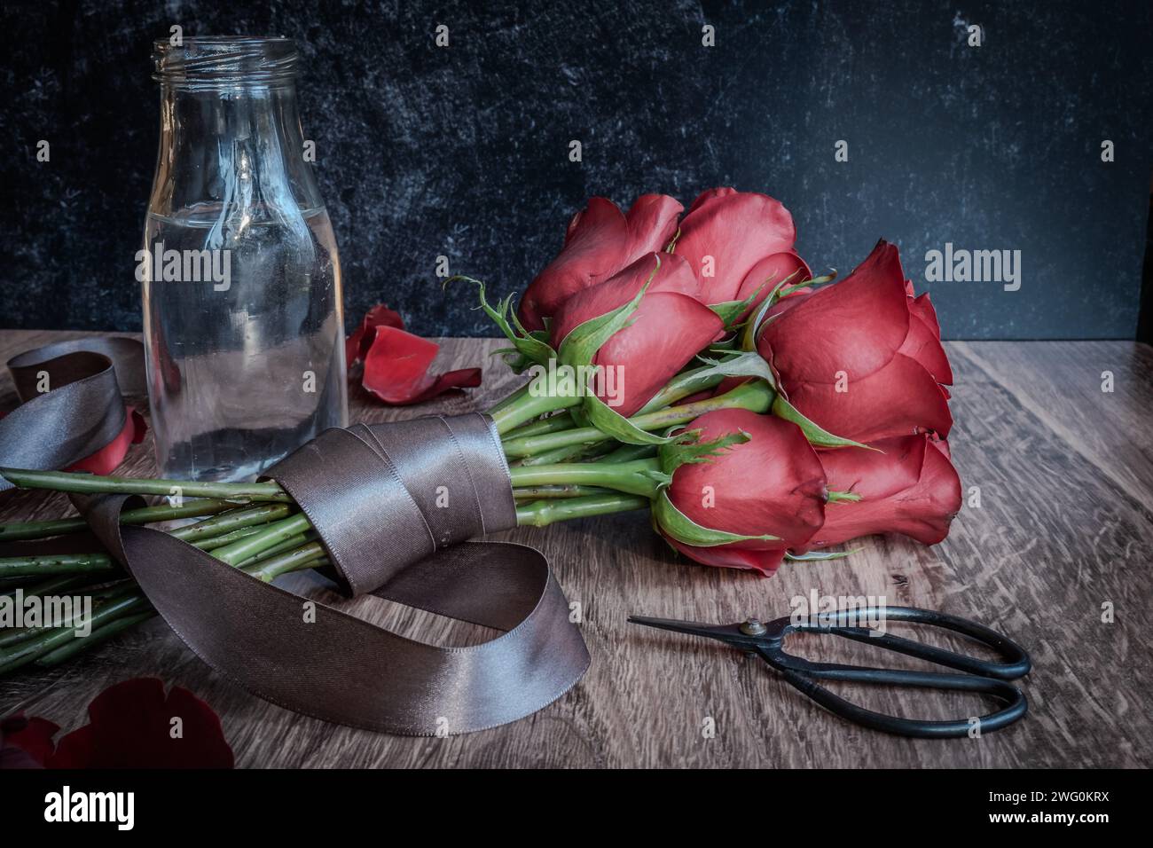Bouquet of blooming red roses wrapped in gray ribbon Stock Photo - Alamy