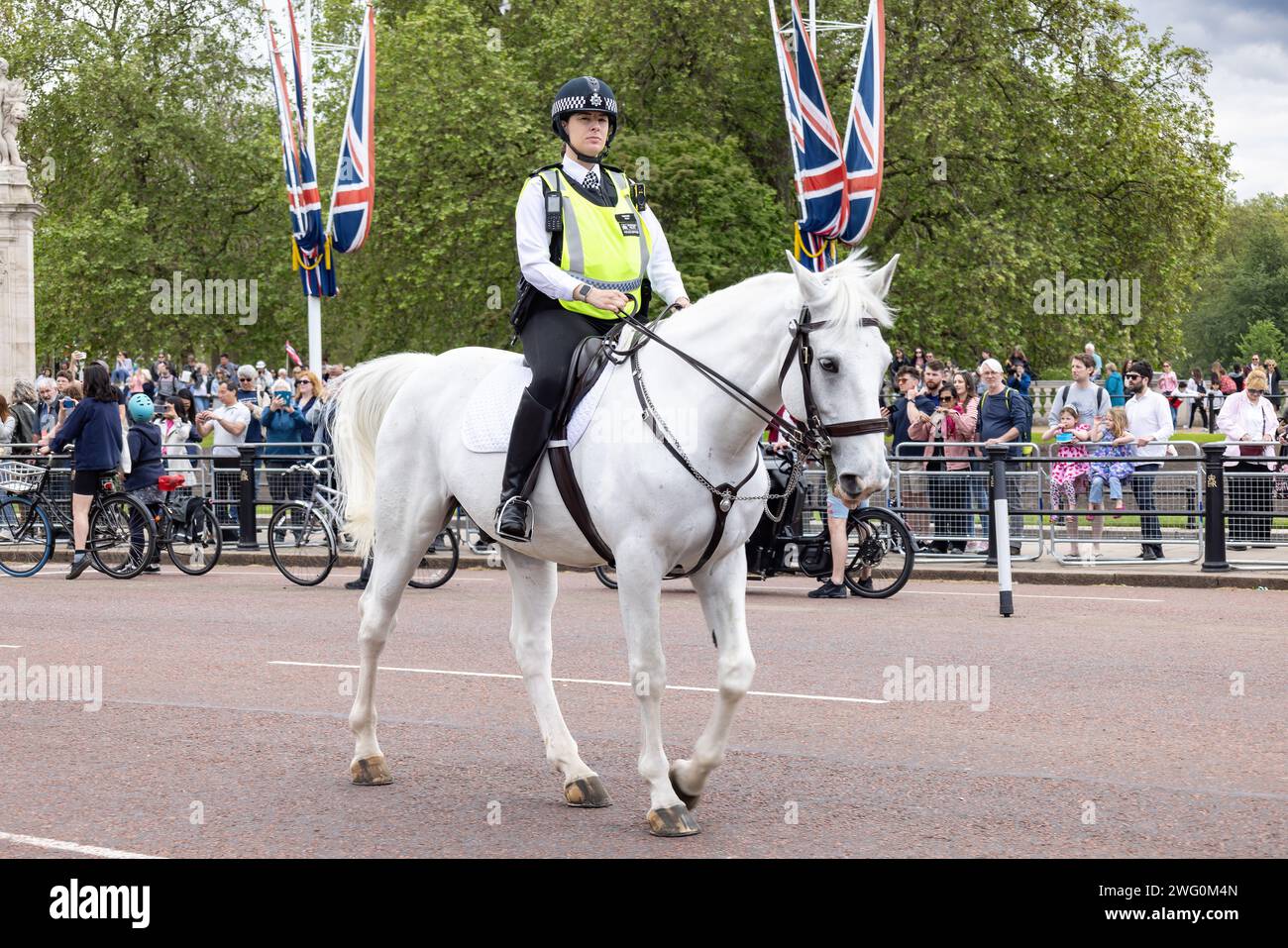 London, UK - May 21, 2023: Unidentified London police woman officer riding a white horse is on duty during the changing of the guard at Buckingham Pal Stock Photo