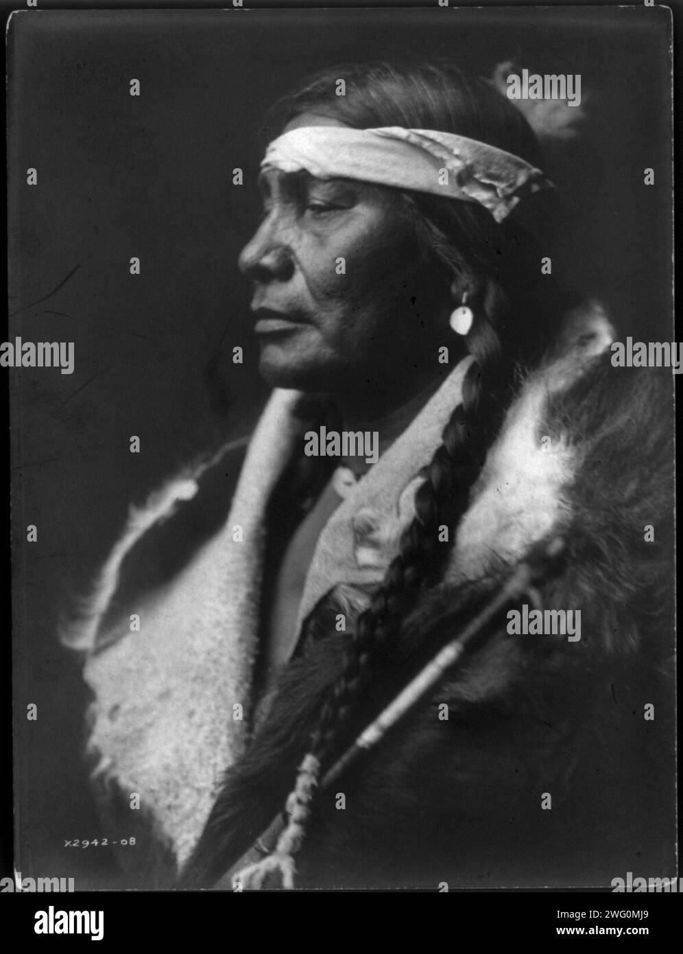 Assiniboin Boy-Atsina, c1908. Assiniboin Boy, an Atsina man, head-and-shoulders portrait, facing left. Stock Photo