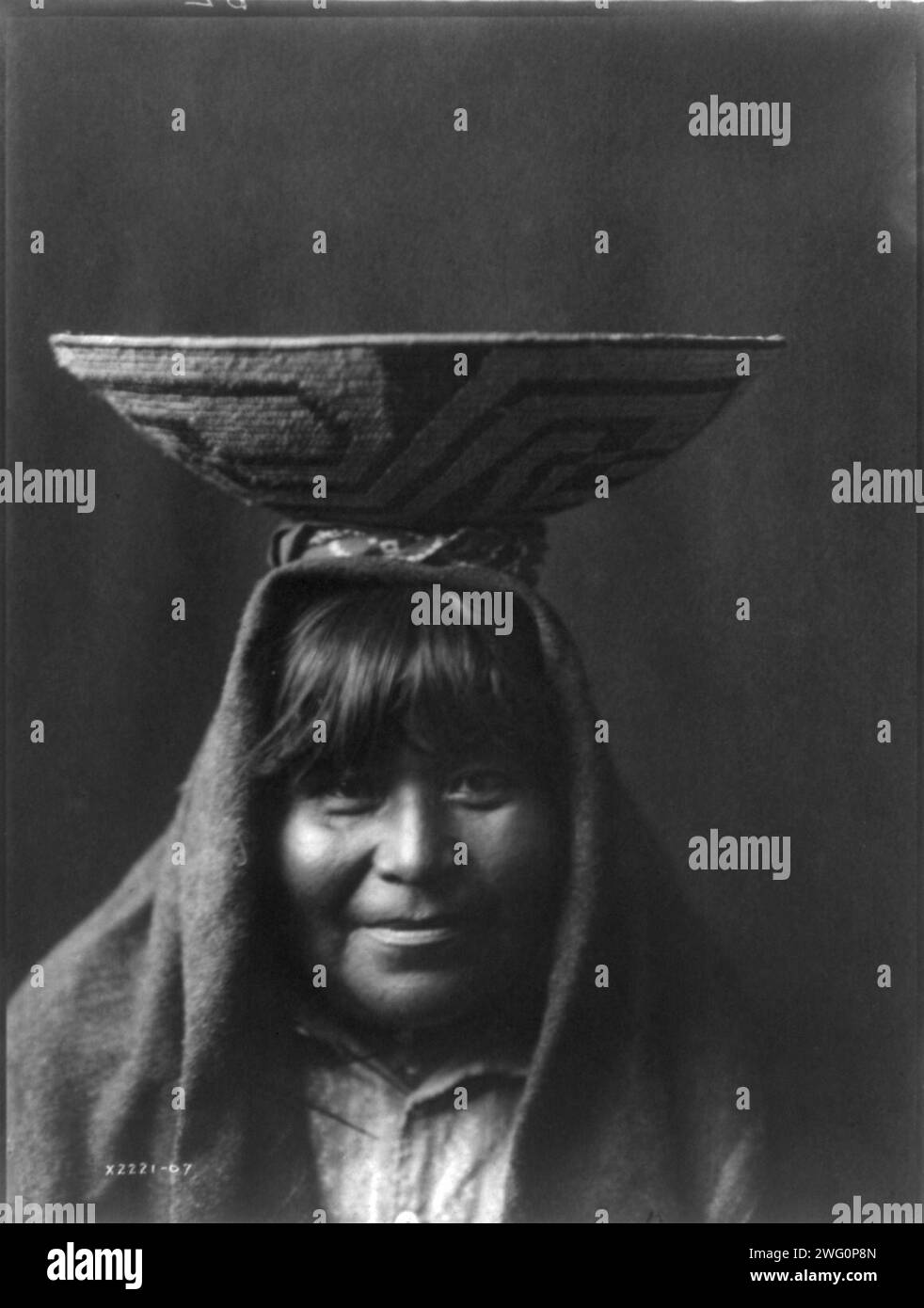 Pima matron, c1907. Head-and-shoulders portrait of Indian woman with bowl on her head. Stock Photo