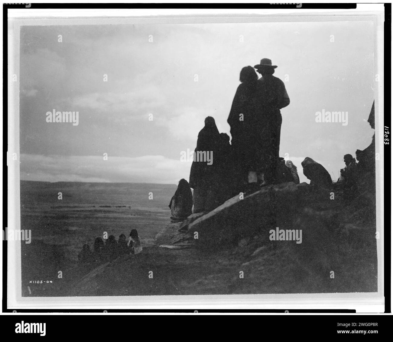 Watching the morning races, c1905. Group of Hopi Indians looking into the distance at valley floor. Stock Photo