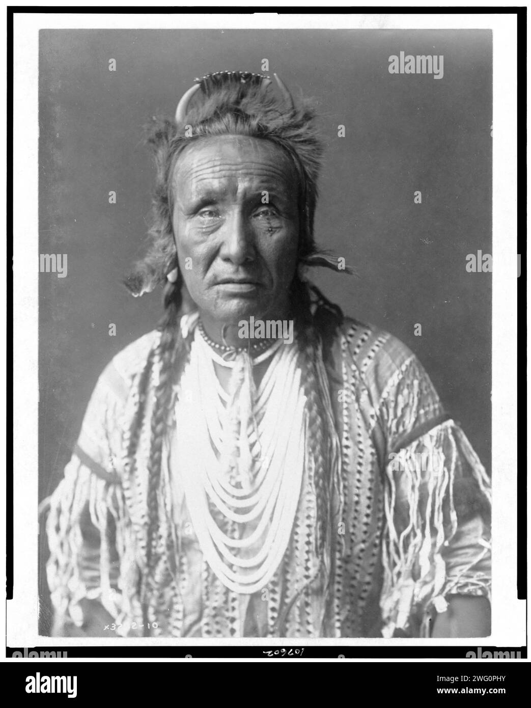 The Grizzly Bear, Piegan, halflength portrait, facing front, c1910