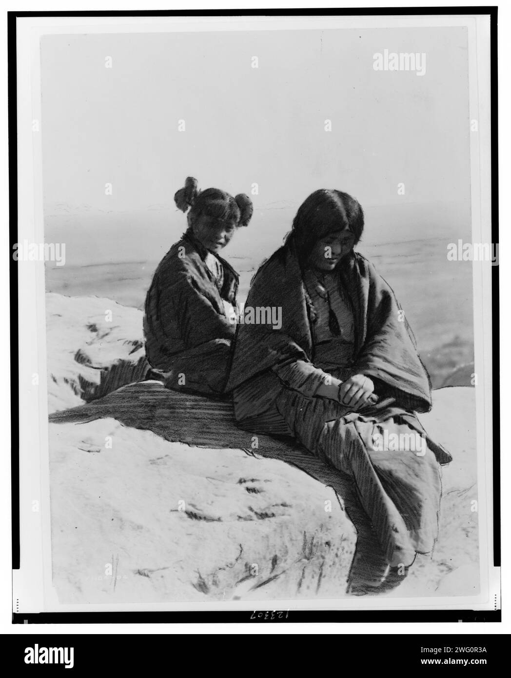 Maiden and Matron, c1905. Two Hopi females sitting on a rock. Stock Photo