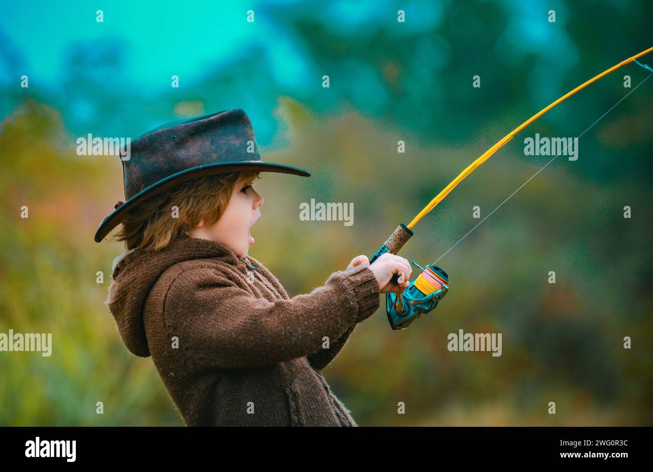 Kid fishing with spinning reel. Kids fly fishing Stock Photo