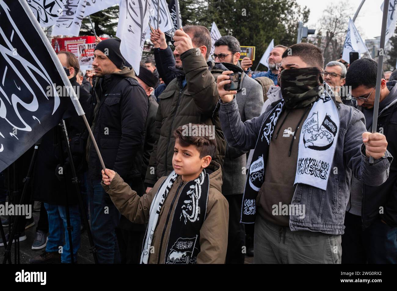 Ankara, Turkey. 28th Jan, 2024. A child waves a caliphate flag during