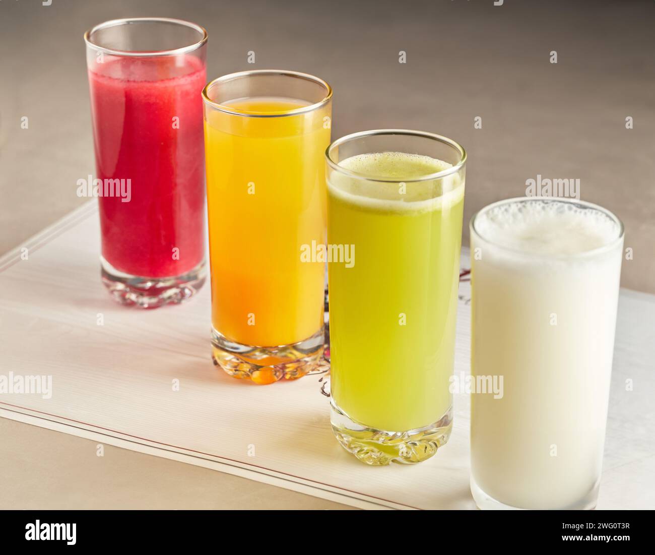 A closeup of four glasses of fruit-infused beverages Stock Photo