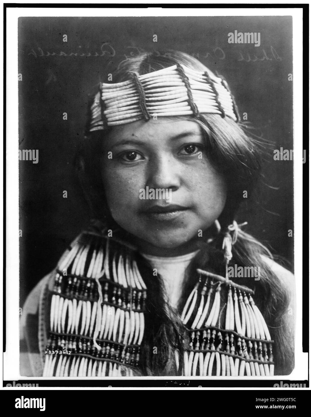 Shell ornaments-Quinault, c1913. Young Indian, head-and-shoulders portrait, facing front, wearing shell ornaments. Stock Photo