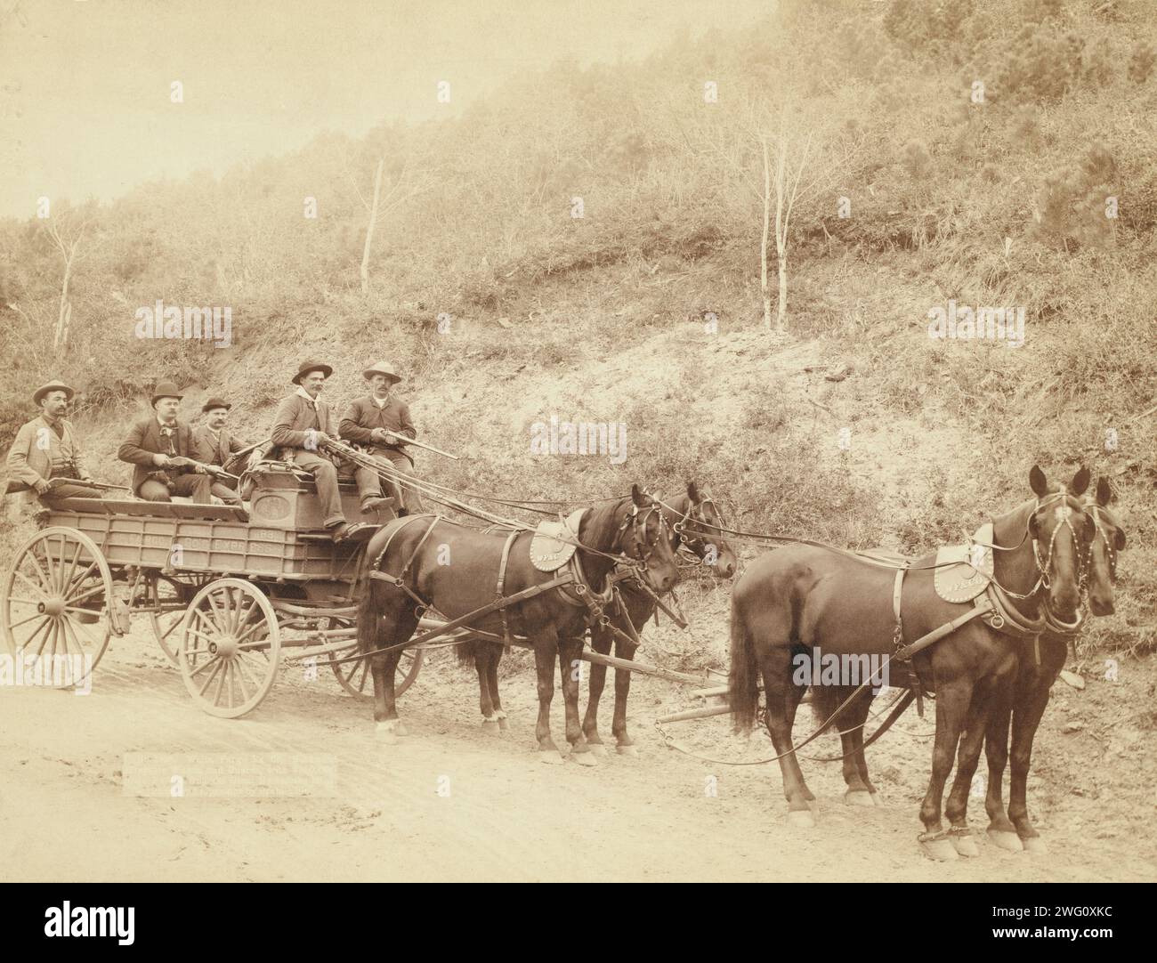 Wells Fargo Express Co. Deadwood Treasure Wagon and Guards with $250,000 gold bullion from the Great Homestake Mine, Deadwood, S.D., 1890 []. Five men, holding rifles, in a horse-drawn, uncovered wagon on a country road. Stock Photo