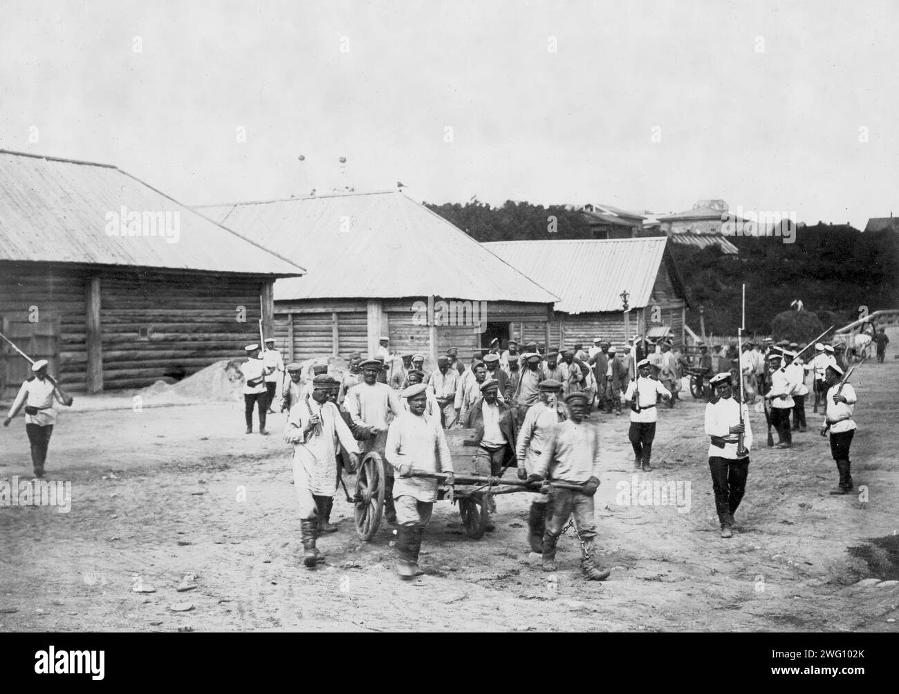 Work of Hard Labor Convicts, 1890. The photographs were taken on Sakhalin Island during the late 19th and early 20th centuries and provide rare glimpses of the island's settlements, prisons, and inhabitants. Sakhalin Island was used by imperial Russia as a penal colony and place of exile for criminals and political prisoners. The collection depicts public life and institutions in the town of Aleksandrovsk Post, convicts working under harsh conditions or in chains, and political prisoners. The photographs also show the daily life both of the Nivkh people, indigenous to the northern part of the Stock Photo