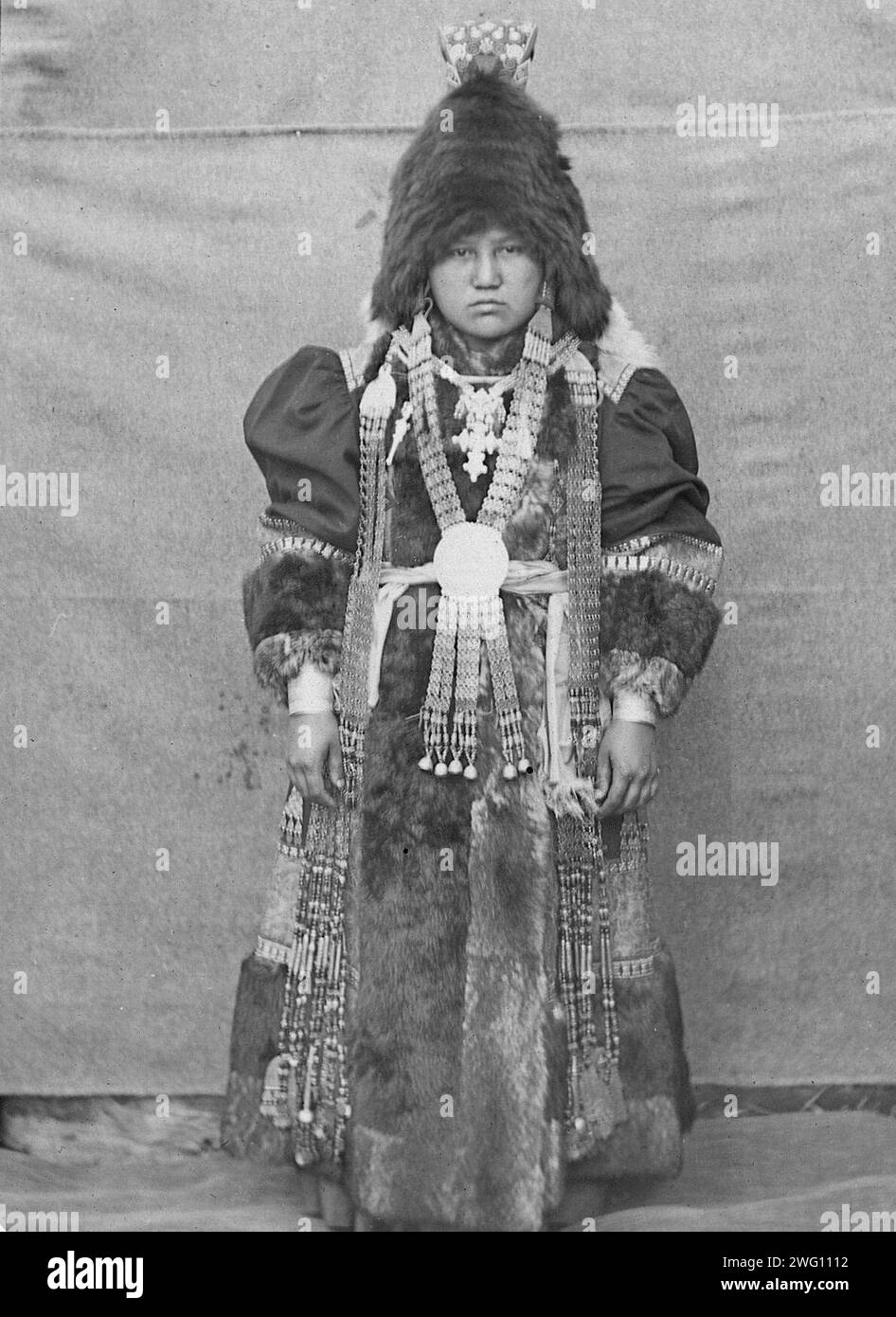 Yakut woman in festive attire, 1890. The album &quot;Views of the Yakutsk Region&quot; contains 151 photographs. Subjects include the Lena River shore; various forms of river transport--including boats, rafts, trade barges, and steamships; post offices along the Lena highway, and transport by horse and reindeer. Several of the photographs are signed with the initials &quot;I. P.&quot; Irkutsk State University Stock Photo