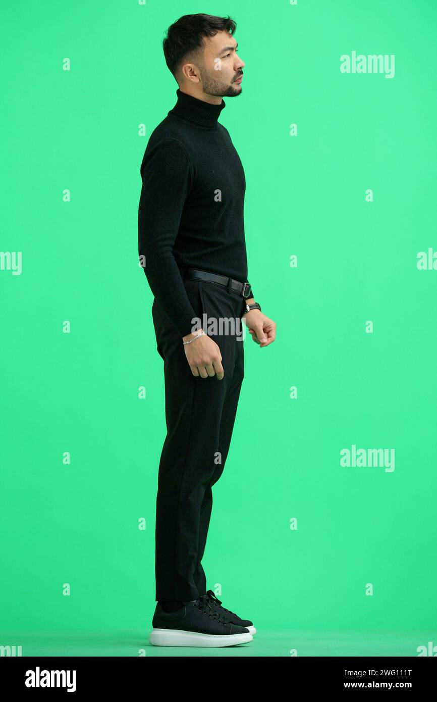 Man, on a green background, full-length Stock Photo