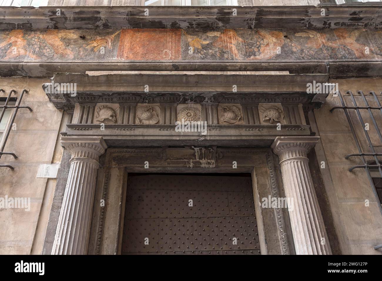 Historical frescoes above the entrance door at Palazzo Pinelli Parodi