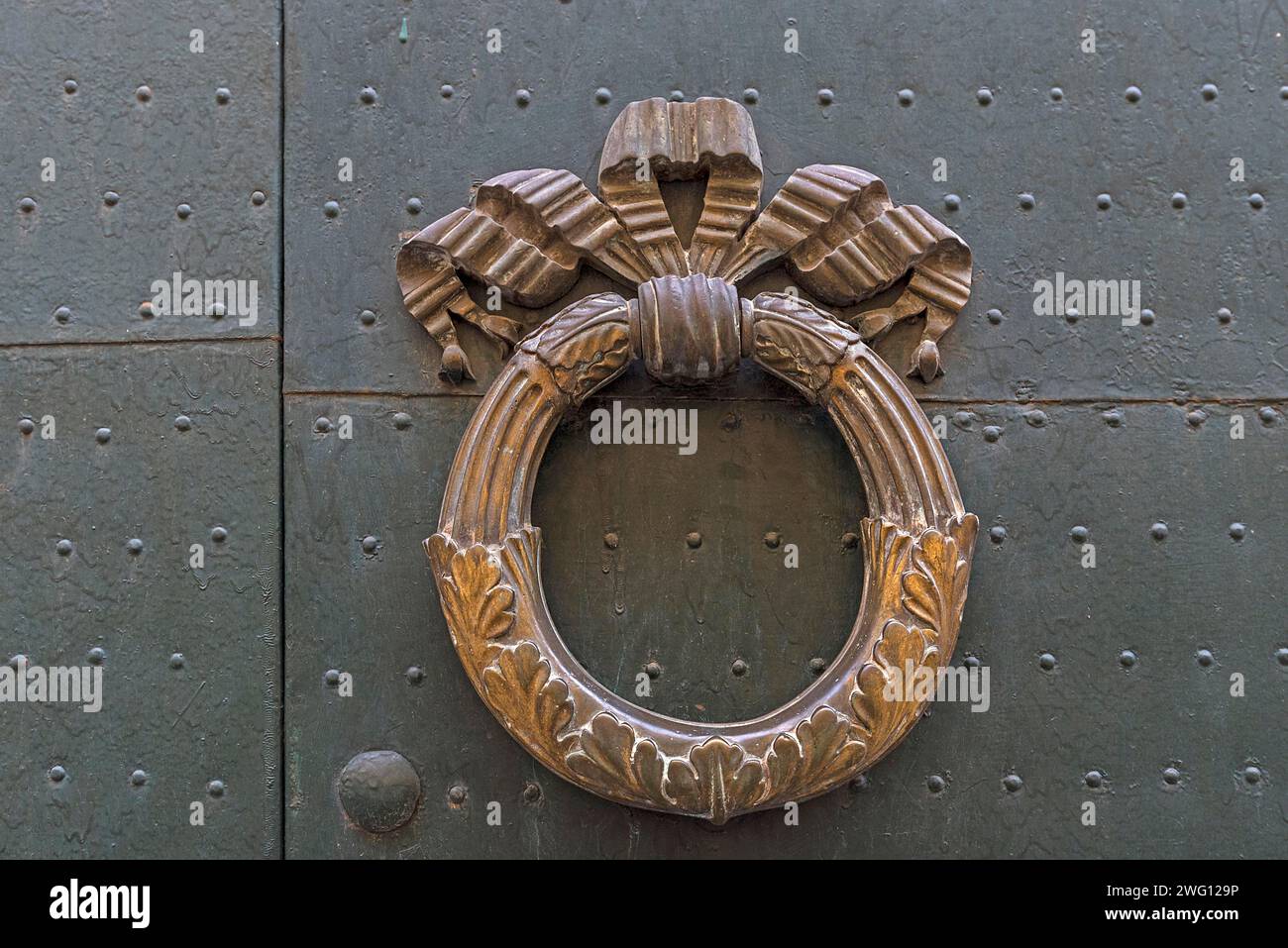 Brass door knocker on a front door in the historic centre, Genoa, Italy Stock Photo