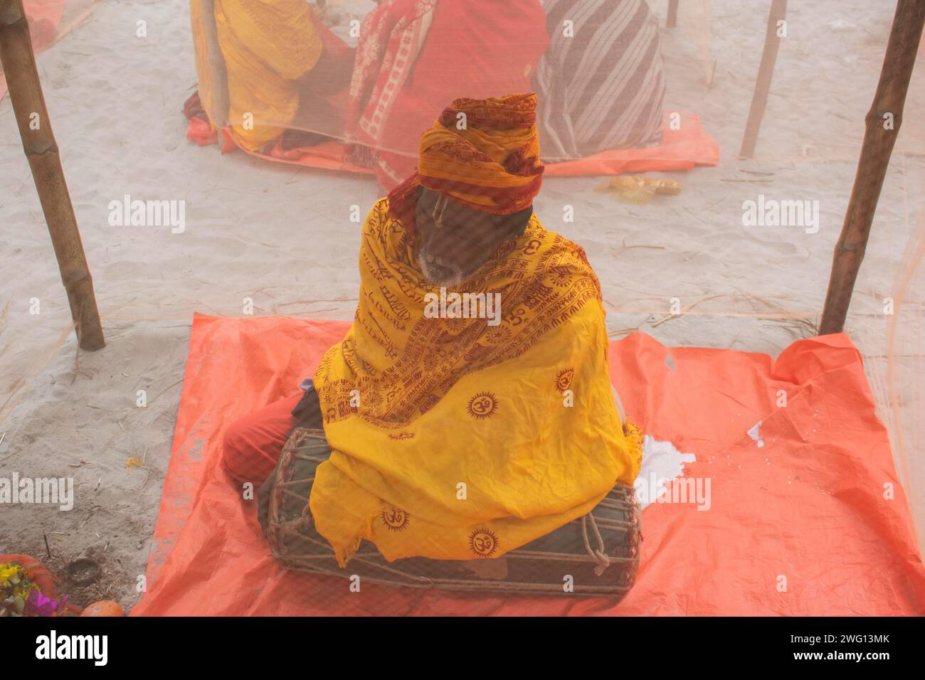 Devotees offer prayers at a tent city on the eve of consecration ...