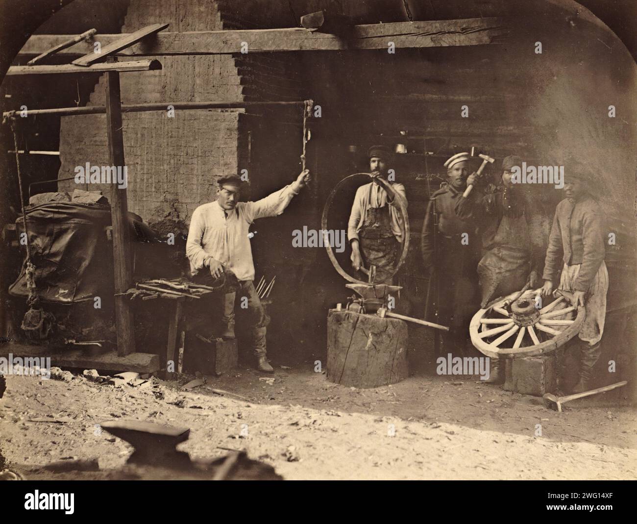 Hard Labor Convicts Working in the Blacksmith's Shop, 1891. One of 74 views taken in July 1891 and contained in the albumTipy i vidy Nerchinskoi katorgi (Views and inhabitants of Nerchinsk hard labor camps). The Nerchinskkatorgawas part of the katorga (forced labor) system of imperial Russia, located in the province of Transbaikalia (present-day Zabaykal'skiy Kray), near the Russian border with China. The katorga was administered by the Ministry of Interior and included prisons at Akatuy, Kara, Aleksandrovsk, Nerchinskii Zavod, and Zerentuy, all of which are depicted in the album. National Lib Stock Photo