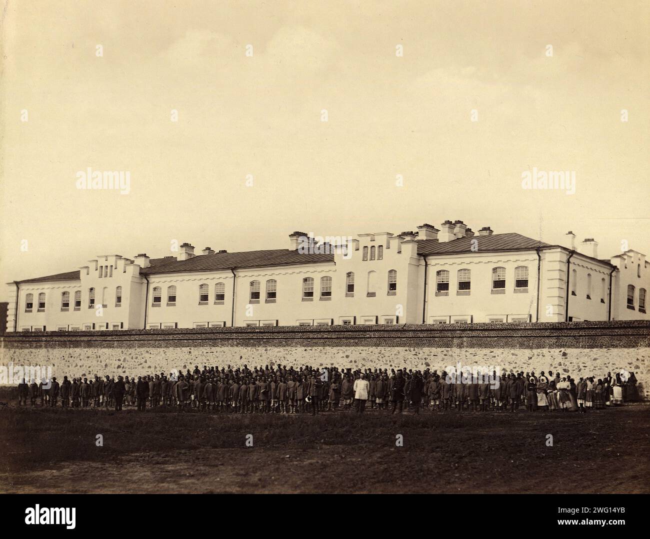 Internees Praying outside the Gornyi Zerentui Prison, 1891. One of 74 views taken in July 1891 and contained in the albumTipy i vidy Nerchinskoi katorgi (Views and inhabitants of Nerchinsk hard labor camps). The Nerchinskkatorgawas part of the katorga (forced labor) system of imperial Russia, located in the province of Transbaikalia (present-day Zabaykal'skiy Kray), near the Russian border with China. The katorga was administered by the Ministry of Interior and included prisons at Akatuy, Kara, Aleksandrovsk, Nerchinskii Zavod, and Zerentuy, all of which are depicted in the album. National Lib Stock Photo