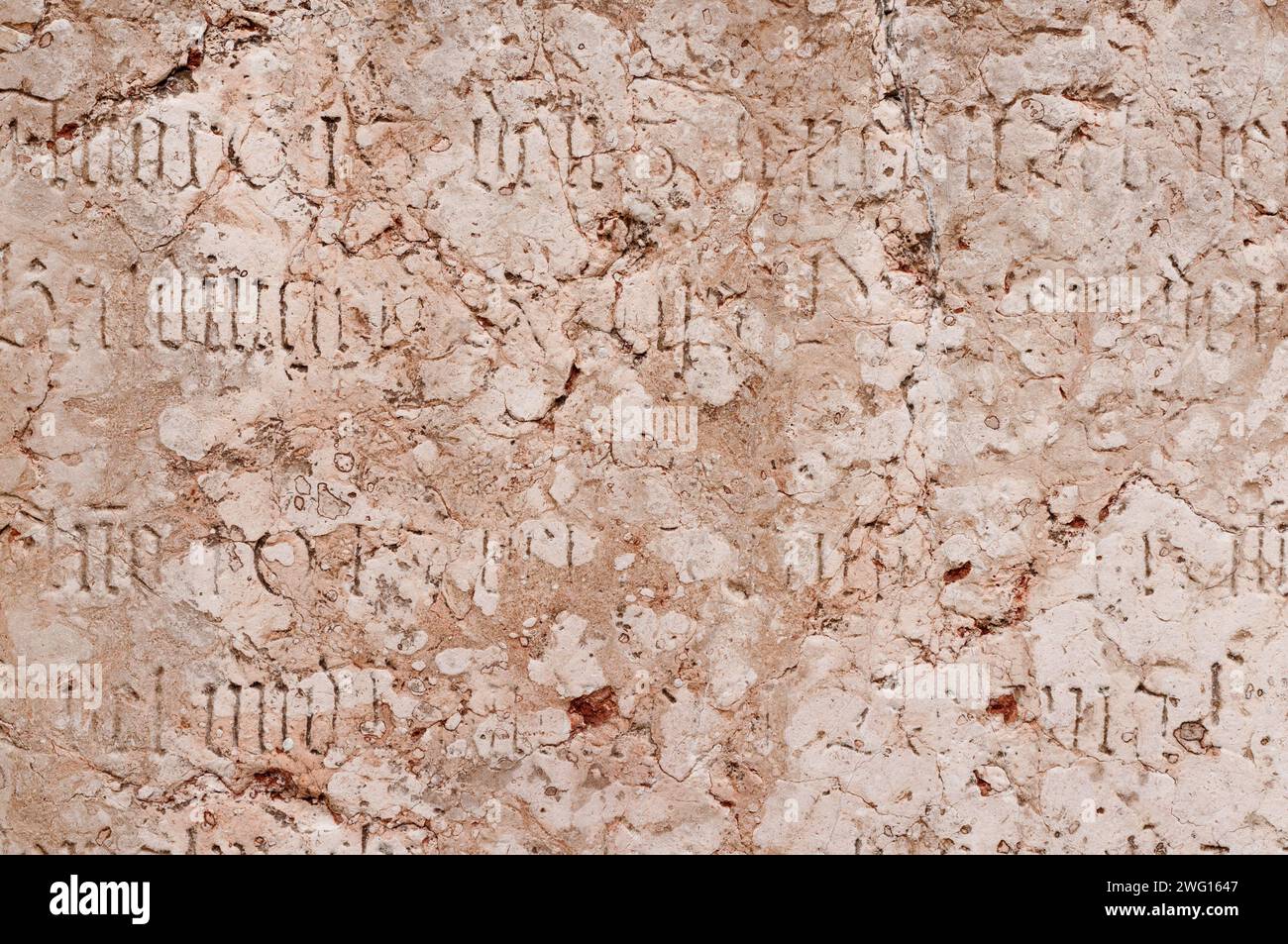An ancient wall with historic inscriptions etched into it Stock Photo