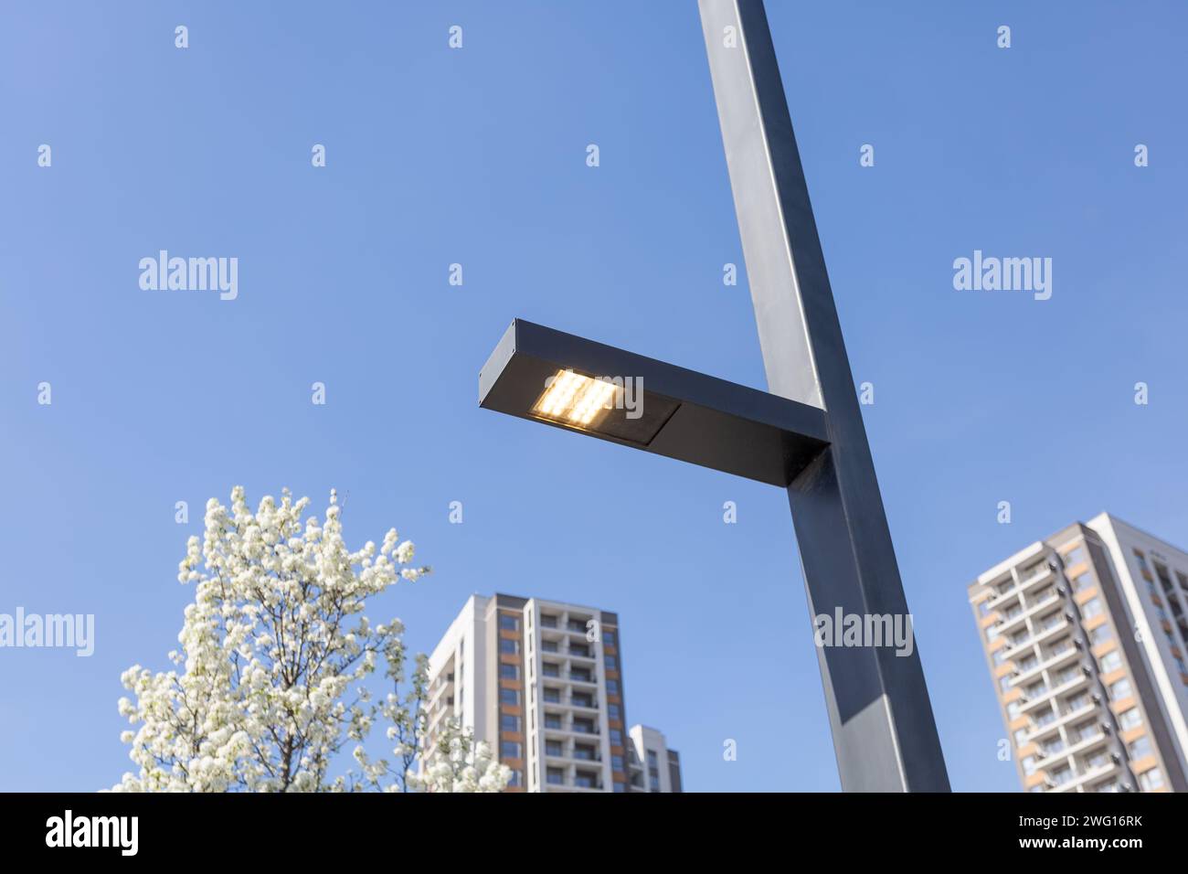 led street light lit on during daytime Stock Photo - Alamy