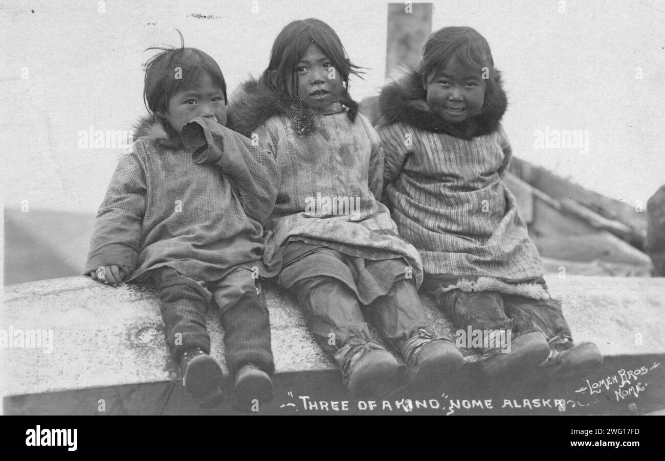 Three Eskimo children seated side by side, between c1900 and c1930 ...