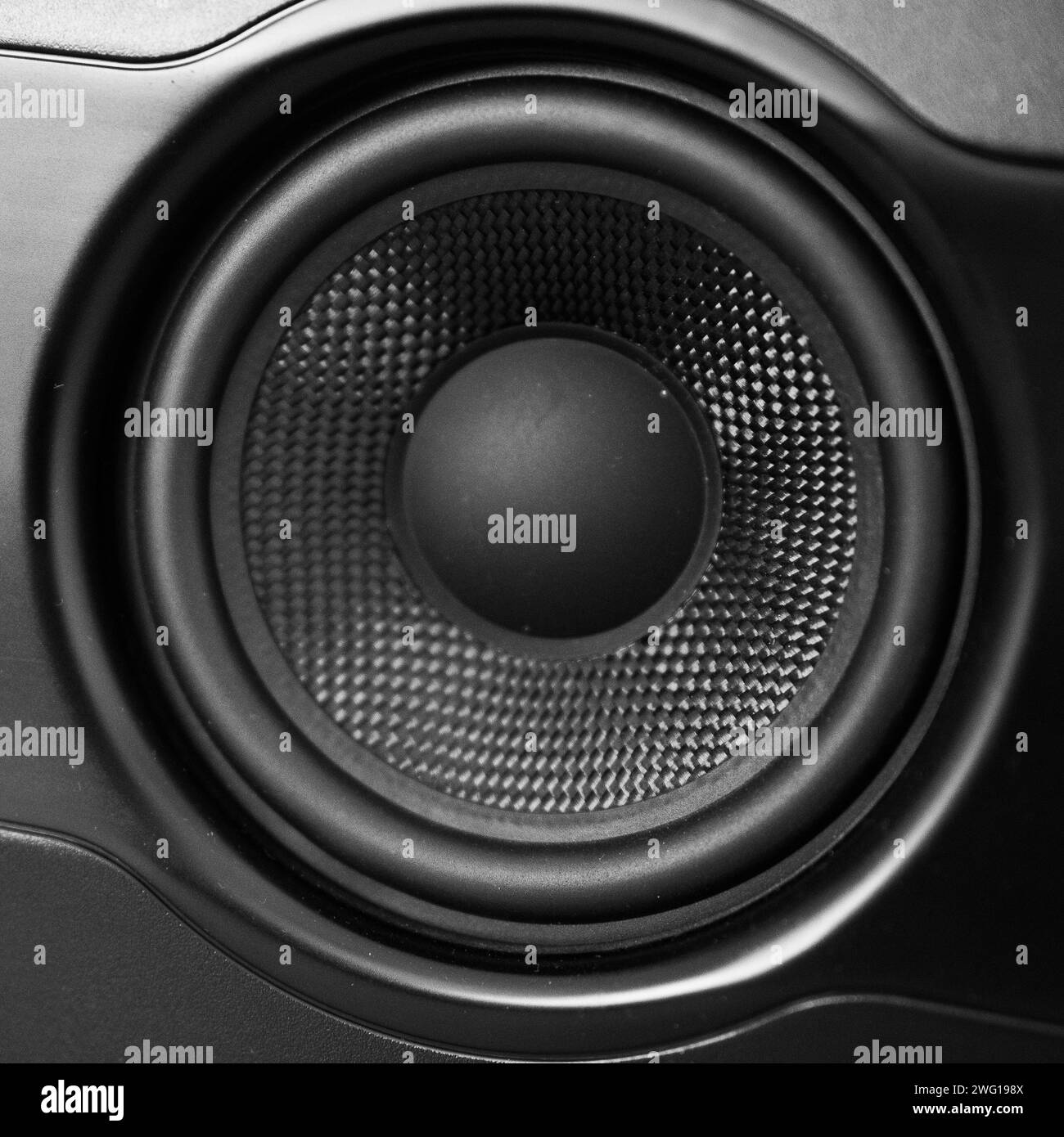 A closeup of a black speaker cone. Stock Photo