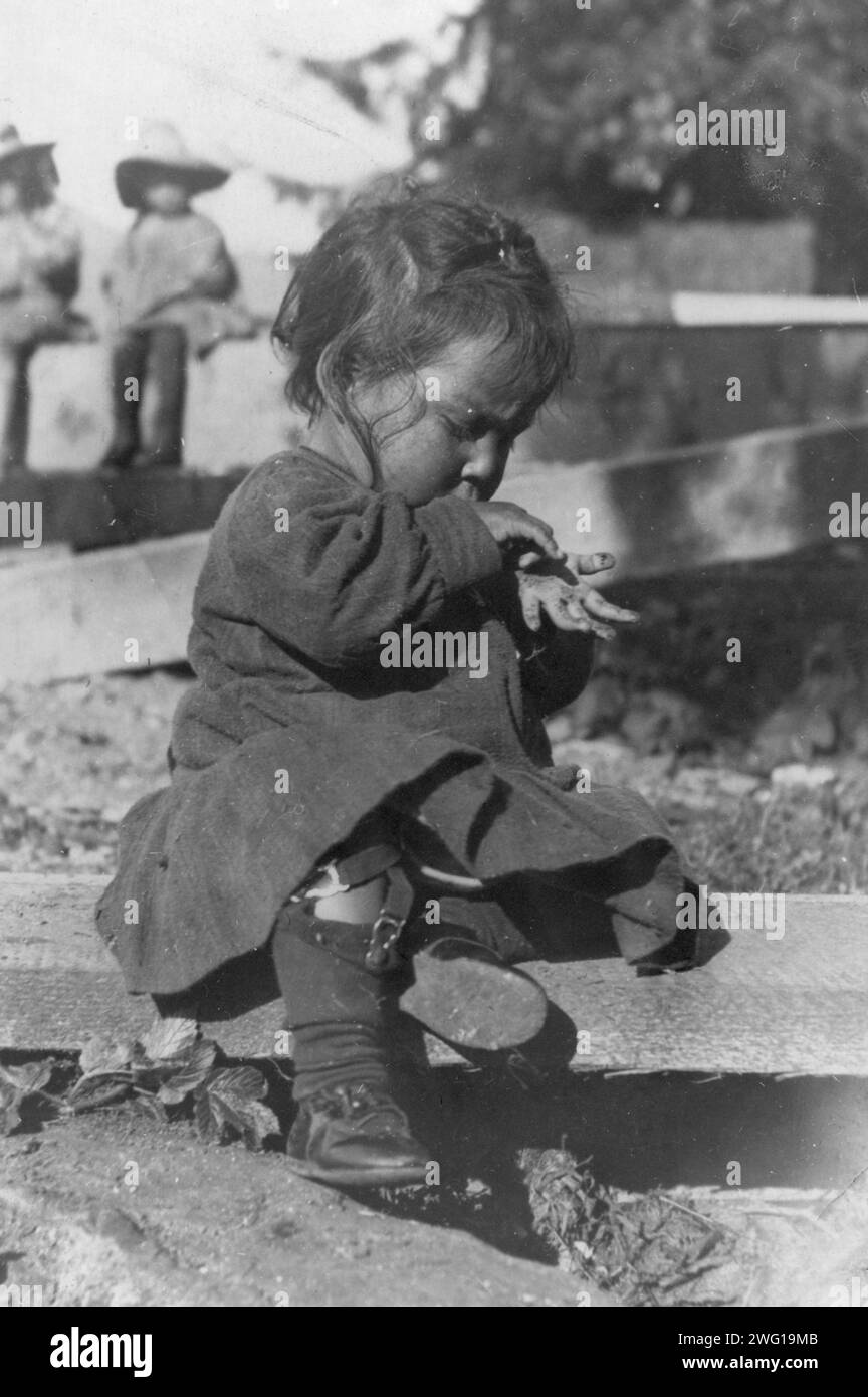 Young Eskimo child seated on board, between c1900 and c1930 Stock Photo ...