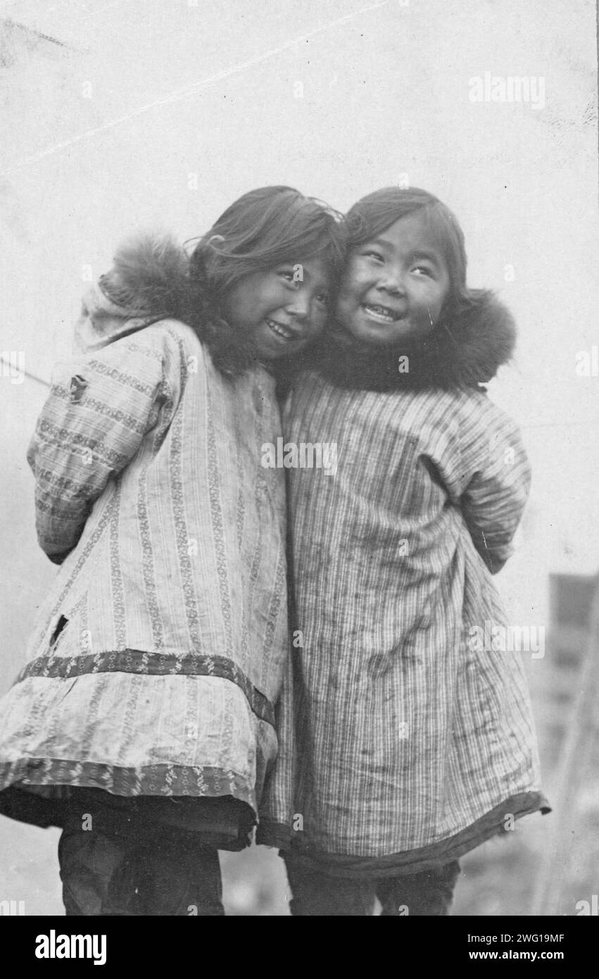 Two Eskimo girls standing side by side, between c1900 and c1930 Stock ...