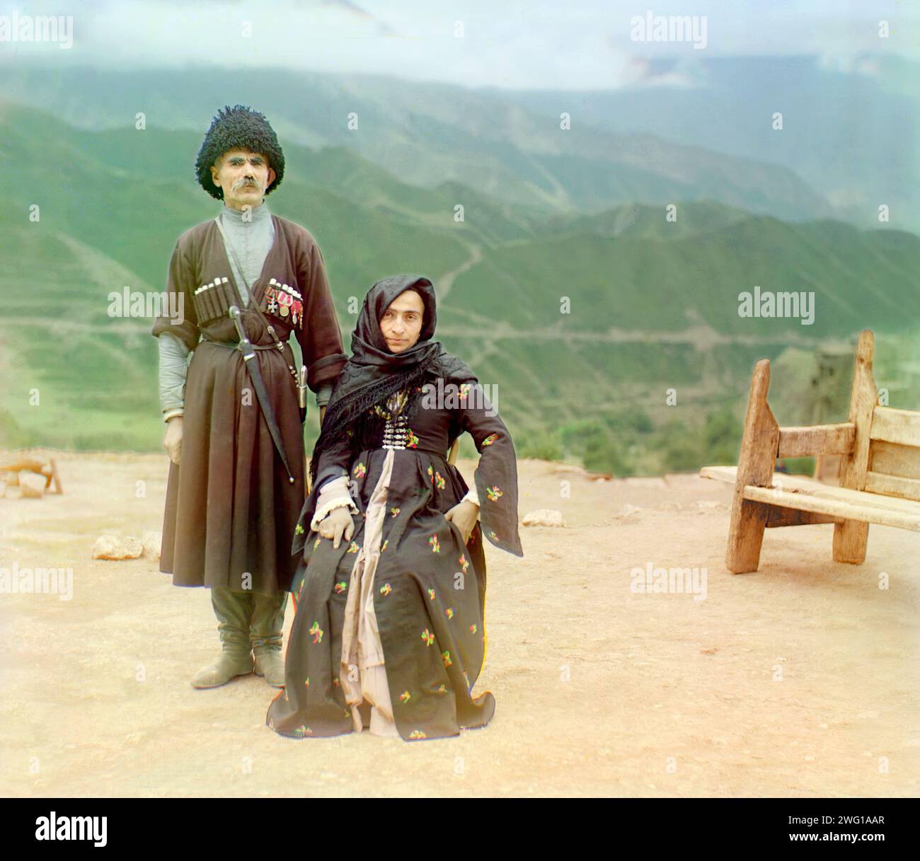 Dagestani types, between 1905 and 1915. Dagestani couple posed outdoors for a portrait. A couple in traditional dress poses for a portrait in the mountainous interior region of Gunib on the north slope of the Caucasus Mountains in what is today the Dagestan Republic of the Russian Federation. Stock Photo