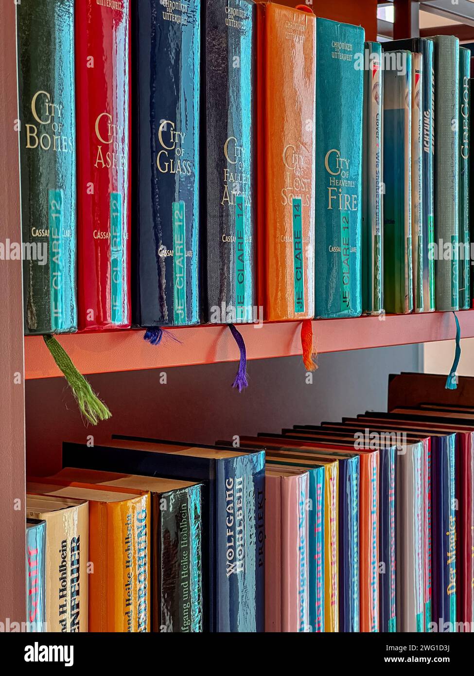 Bookshelves with various books in the city library. Stock Photo