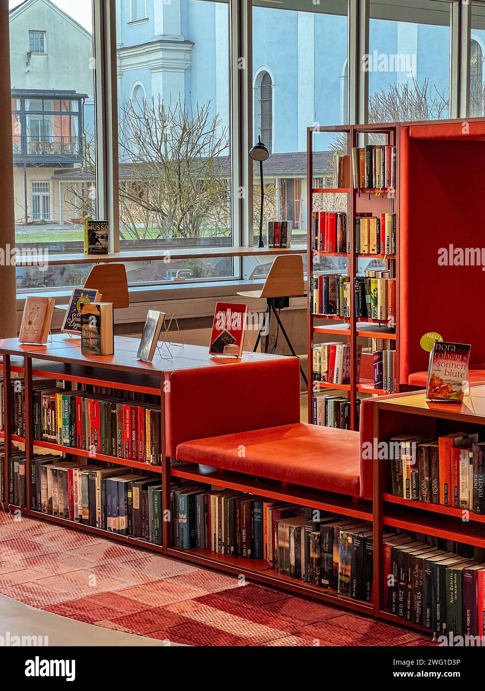 Bookshelves with various books in the city library. Stock Photo