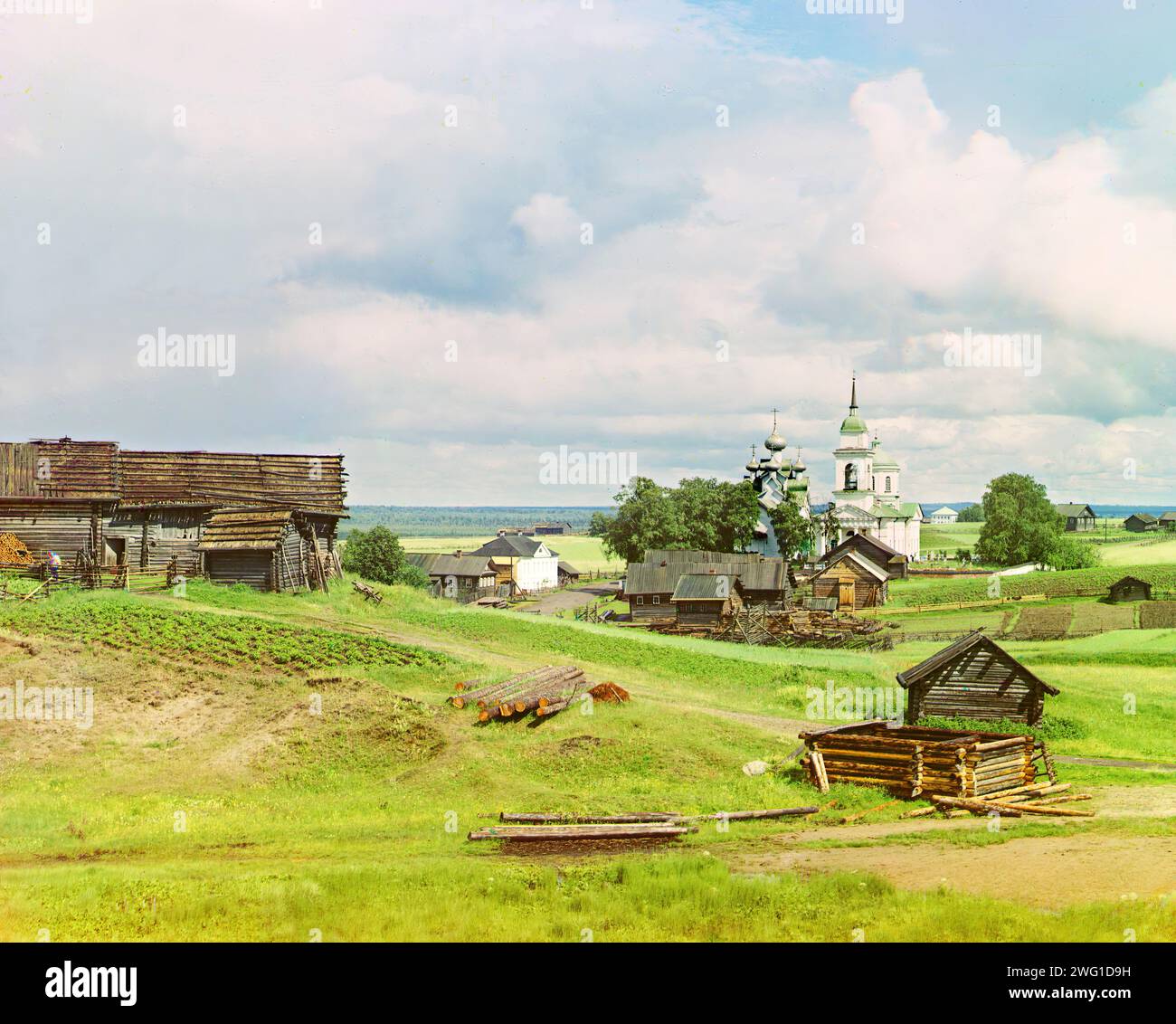 Village of Paltoga [Russian Empire], 1909. Log cabin under construction in foreground, Vologda Oblast, Russia. Russian chemist and photographer Sergey Prokudin-Gorsky (1863-1944) was a pioneer in colour photography which he used to document early 20th-century Russia and her empire, including the vanishing way of life of tribal peoples along the Silk Route in Central Asia. In a railway-carriage darkroom provided by Czar Nicholas II, Prokudin-Gorsky used the three-colour photography process to record traditional costumes and occupations, churches and mosques - many now Unesco World Heritage site Stock Photo