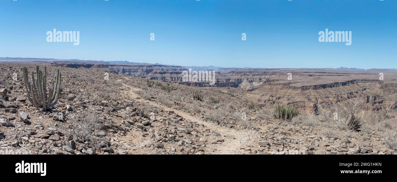 landscape with walk path to Sunset viewpoint on plateau edge, shot in bright late spring light at Fish River Canyon, Namibia, Africa Stock Photo