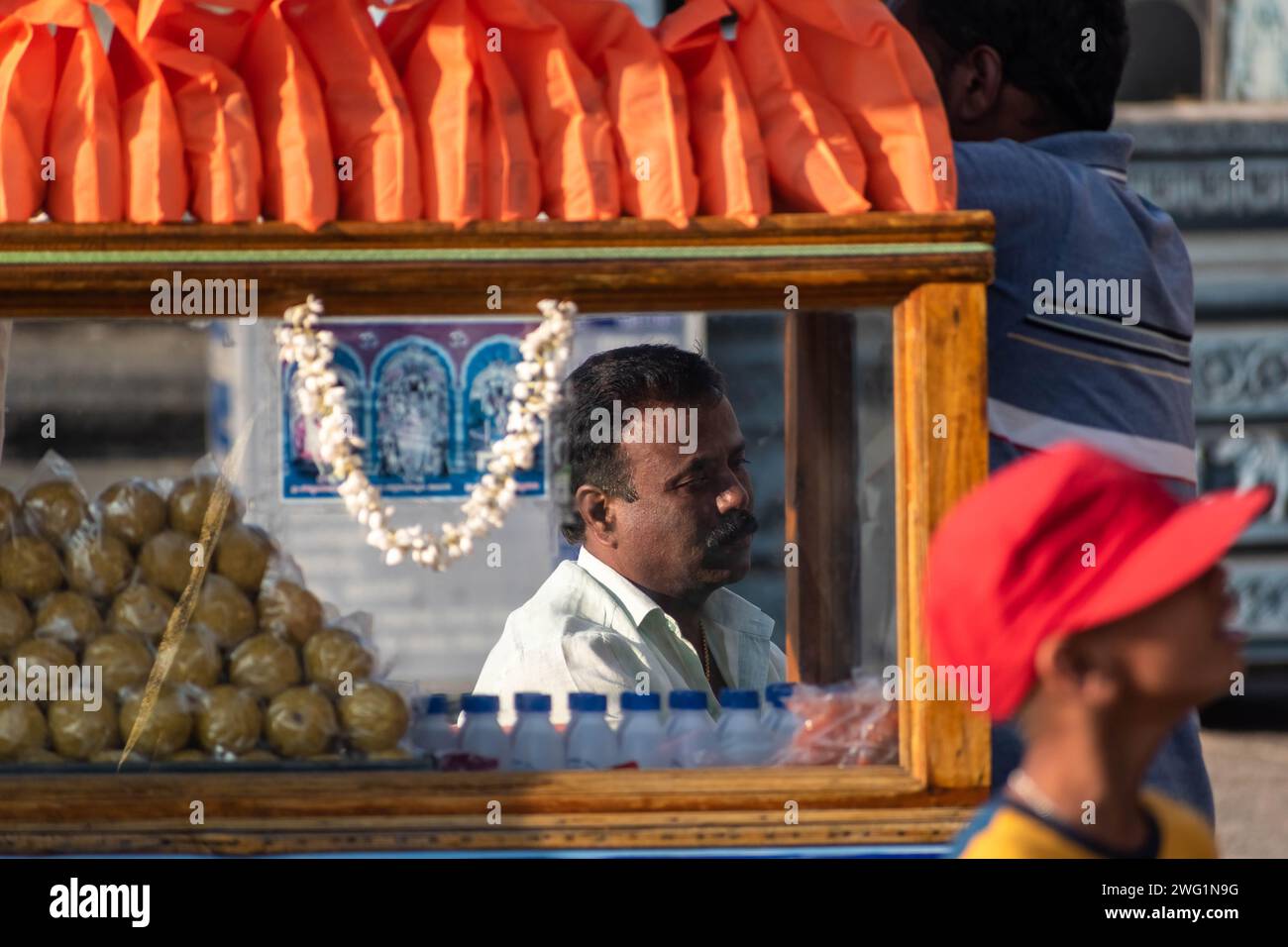 Belur, Karnataka, India - January 9 2023: A street vendor at his colorful snack stall for tourists at the Chennakeshava temple. Stock Photo
