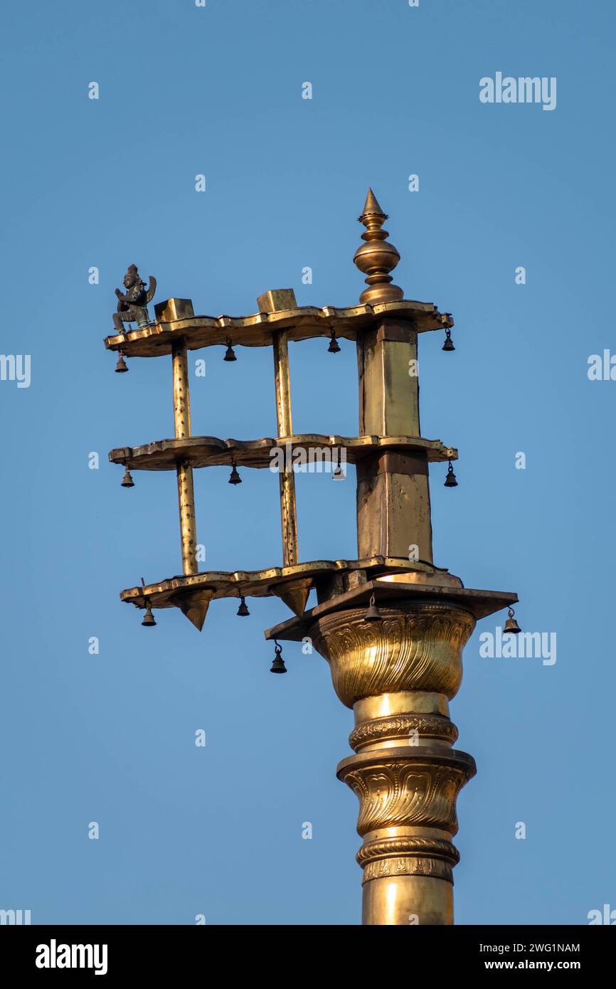 Belur, Karnataka, India - January 9 2023: The golden Dhwaja Stambh pillar in the historic Chennakeshava temple in Belur. Stock Photo