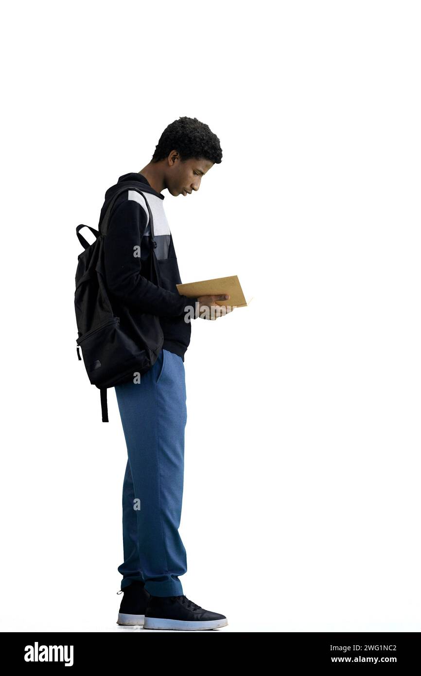 A man, full-length, on a white background, with a backpack, writes Stock Photo