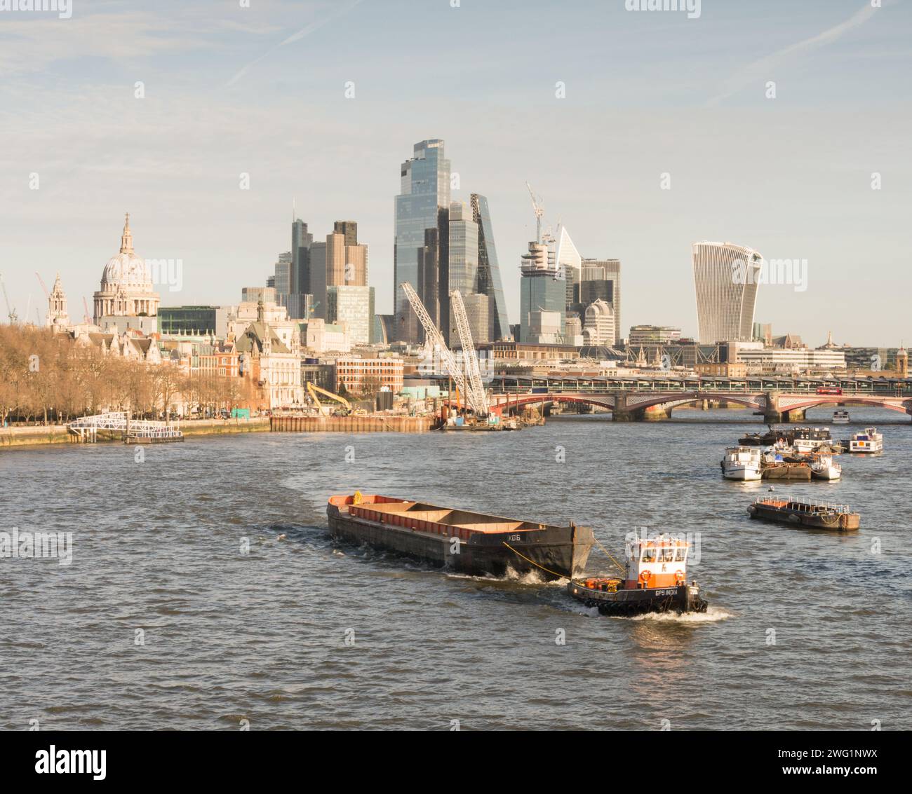Tugboat GPS India on the River Thames, with City of London skyline skyscrapers  in the background, as seen from Waterloo Bridge, London, England, U.K. Stock Photo