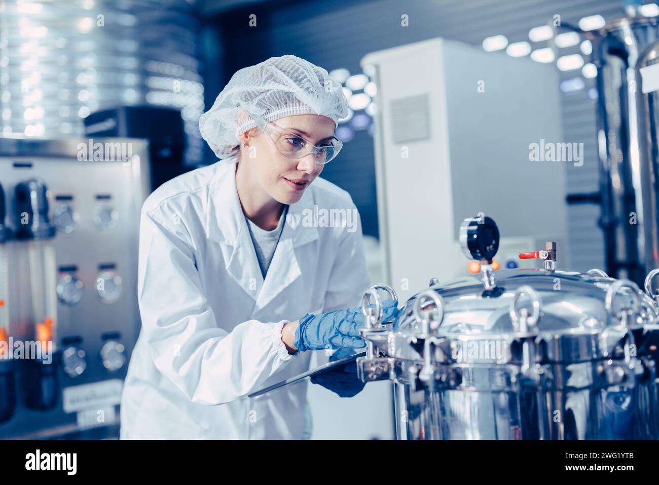 staff work in science medical lab factory check record pressure tank happy working Stock Photo