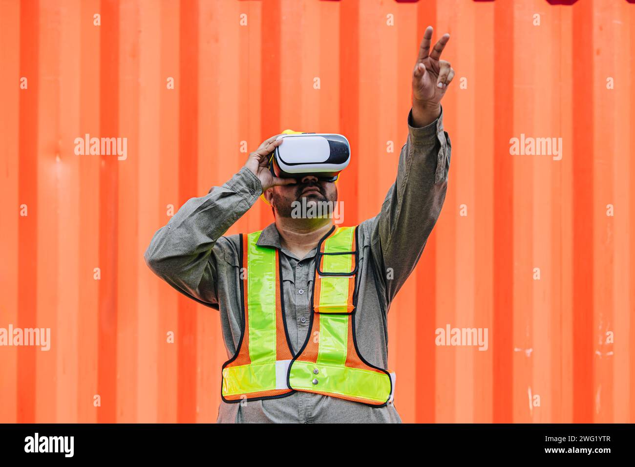 Worker Using VR Vision Pro Technology Equipment Headset Device Work at Container Yard Construction site Innovation in Logistics Industry Stock Photo