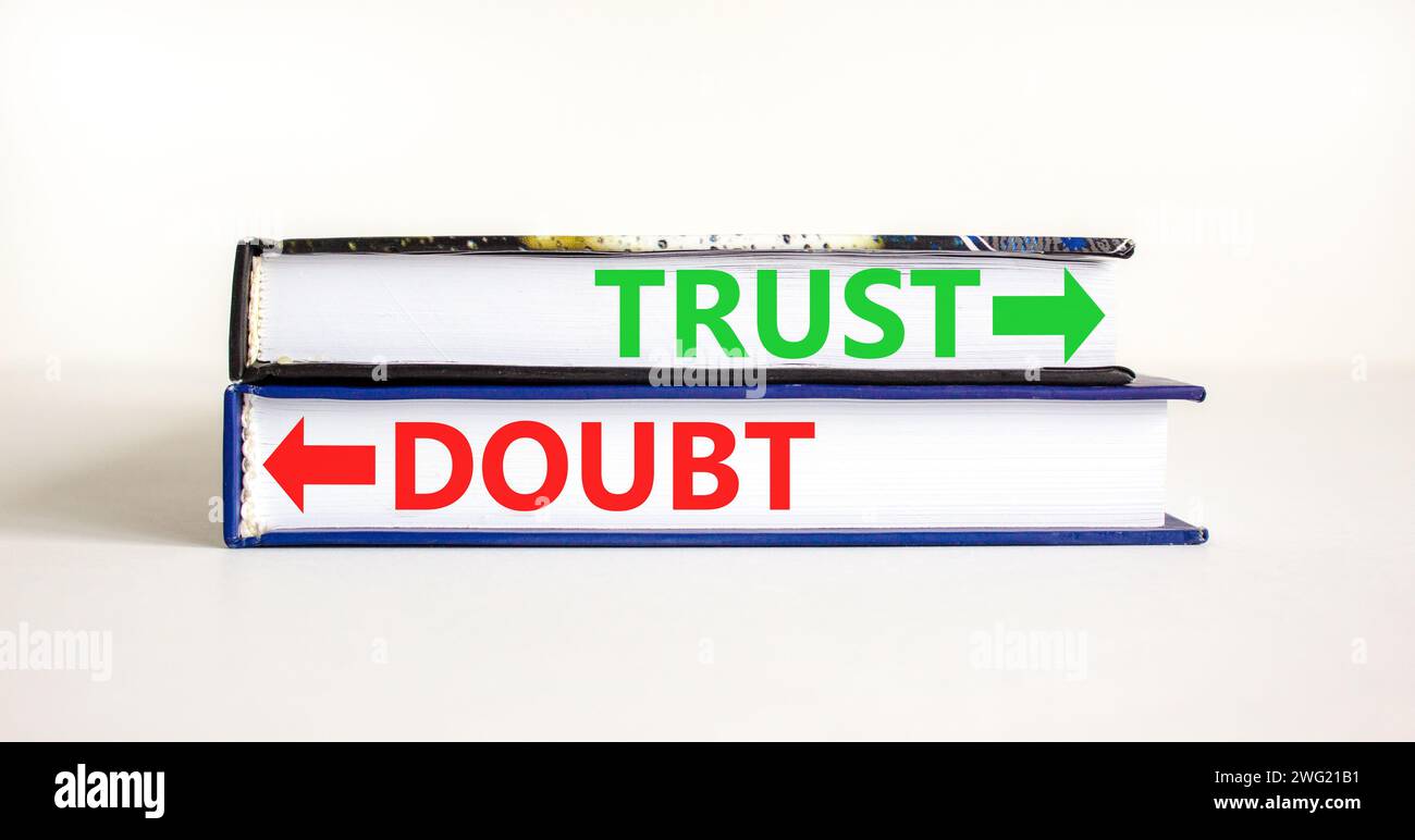 Trust or doubt symbol. Concept word Trust or Doubt on beautiful books. Beautiful white table white background. Business and trust or doubt concept. Co Stock Photo
